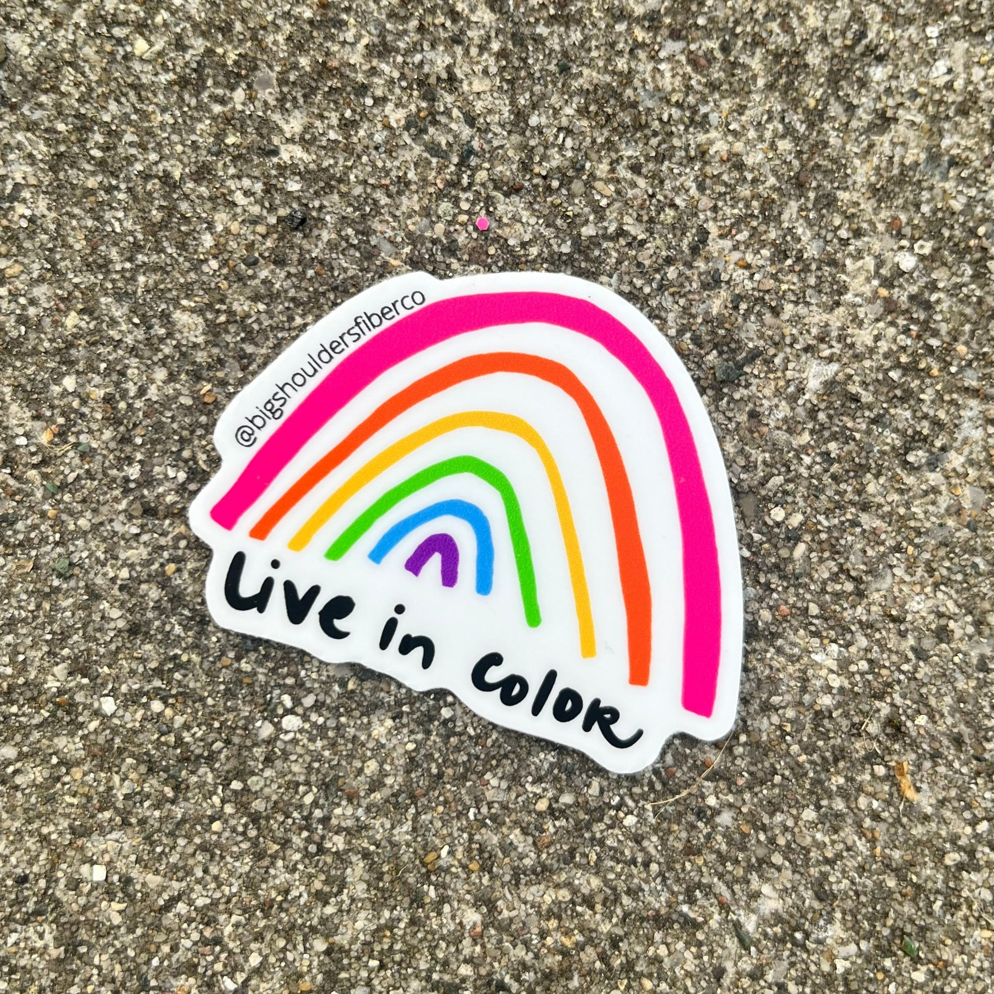 sticker with hand-drawn rainbow and "Live in Color" underneath