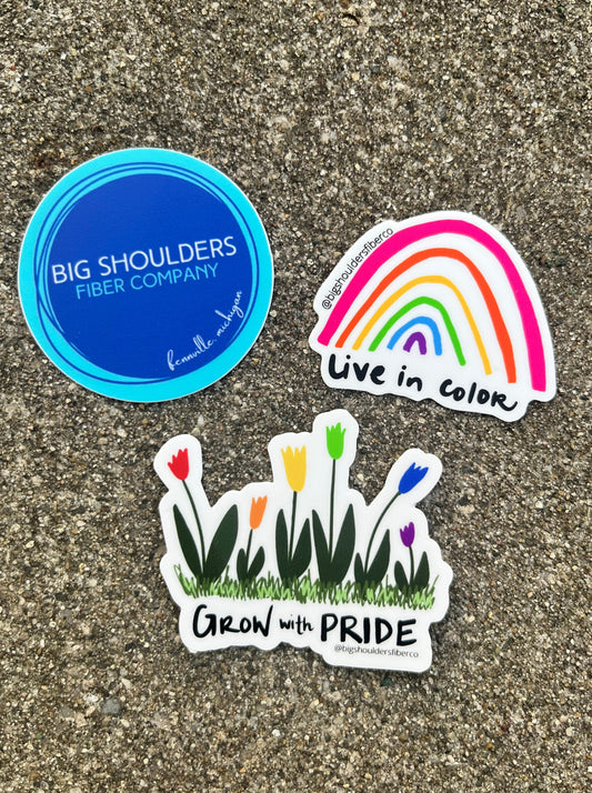 three stickers - Big Shoulders logo, Live in Color Rainbow, and Grow with Pride rainbow tulips